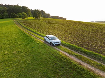 Vehicle travelling along a green country road through wide fields, Renault Megane, Deer E