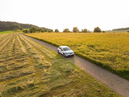 Car driving on a country road through a varied landscape at sunset, Renault Megane, Deer E