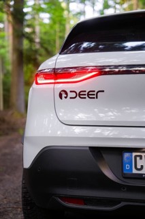 Close-up of a tail light with forest in the background, Renault Megane, Deer E Carsharing, electric