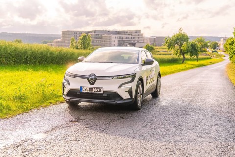 White Renault driving on a country road with the urban background, Renault Megane, Deer E