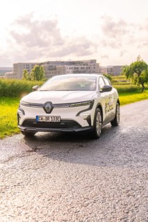 White Renault car on a road with fields and urban landscape in the background, Renault Megane, Deer