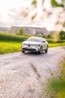 White Renault car on a rural road, surrounded by fields and trees, Renault Megane, Deer E