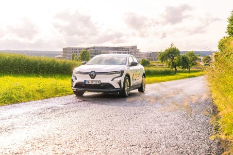 White Renault car driving along a tarmac road in a vast landscape, Renault Megane, Deer E