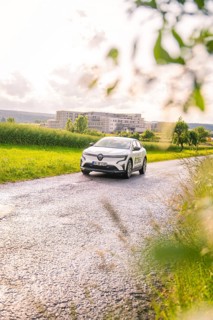 Renault car on a lonely road with trees and buildings in the background, Renault Megane, Deer E