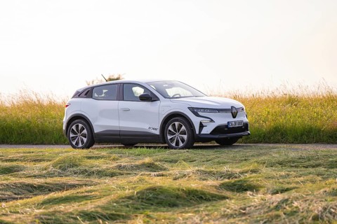 White electric car standing in a meadow on a sunny day, Renault Megane, Deer E- Carsharing,
