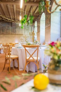 Elegant wedding decoration in a rustic ballroom with candles and flower arrangements, event and