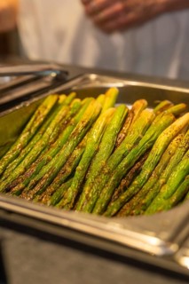Seasoned green asparagus on a tray in a kitchen ready to be served, event and wedding location