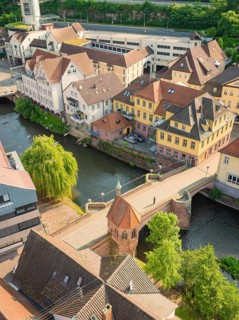 Picturesque town view with river and half-timbered houses next to a stone bridge, Calw, Black