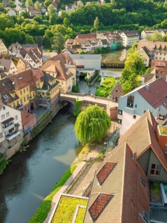Historic town with a river under a bridge and many old buildings, Calw, Black Forest, Germany