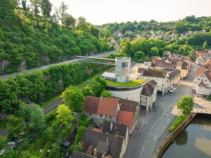 Modern building with a view of an idyllic old town and green hills, Calw, Black Forest, Germany