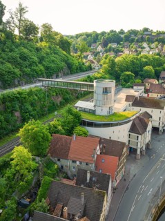 A modern structure with a green roof above a historic urban landscape, Calw, Black Forest, Germany