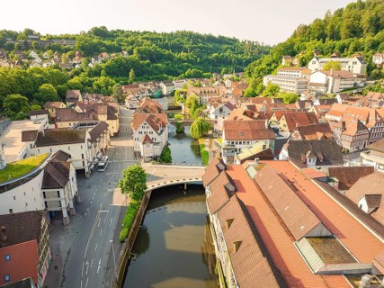 Aerial view of a picturesque town with red tiled roofs and a river, Calw, Black Forest, Germany