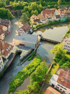 Idyllic town with bridge and green banks along the river, Calw, Black Forest, Germany