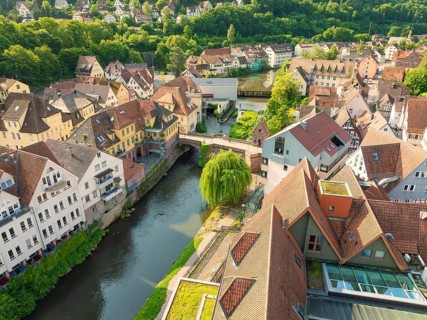 Aerial view of a neighbourhood with river and half-timbered houses under a clear sky, Calw, Black