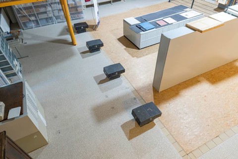Modern storage room with stairs, shelves and boxes with bright light, historical art exhibition in