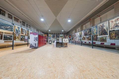 Large exhibition area in an art gallery with paintings on the walls, historical art exhibition in