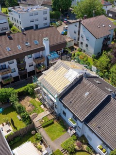 Viewed from above, houses with a partially renovated roof in a green neighbourhood, roof