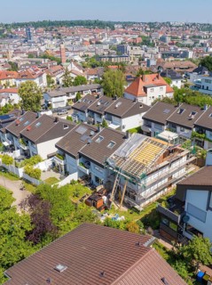 Bird's eye view of a house under renovation in a suburban area with urban view, roof renovation,