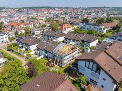 City view with focus on a renovated house roof in a residential area, roof renovation, house