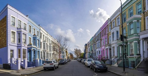 Traditional colorful terraced houses lining a street in notting hill, a popular neighborhood in