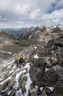 Mountaineer in rocky mountain landscape, at the summit of Keeskopf, behind summit of Petzeck, Hoher