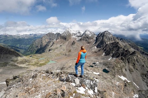 Mountaineer in rocky mountain landscape, at the summit of Keeskopf, behind summit of Petzeck, Hoher