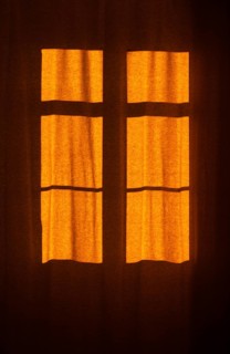 Interior view of a window with red curtain