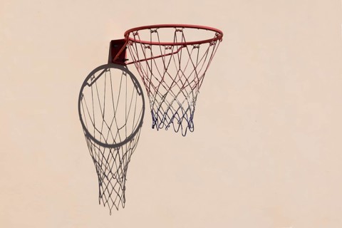 Basketball hoop with shadow cast on a white wall