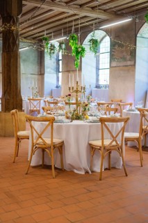 Atmospheric wedding room with round tables and subtle light decorations, event and wedding location