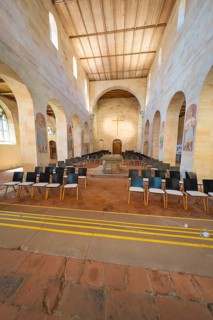 Church interior with organised pews and a central cross, event and wedding location Lorch