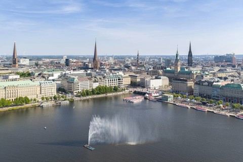 Aerial view of the Inner Alster with Jungfernstieg and Alster fountain against a blue sky, Hamburg,