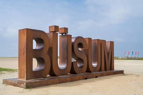 Font with capital letters BÜSUM, sign on the beach, Büsum, North Sea, Schleswig-Holstein, Germany