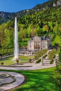 Water parterre with large fountain and portal of Linderhof Castle in spring, municipality of Ettal,