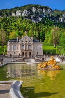 Water parterre with flora fountain and the portal of Linderhof Castle in spring, municipality of
