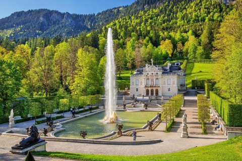 Water parterre with large fountain and portal of Linderhof Castle in spring, municipality of Ettal,