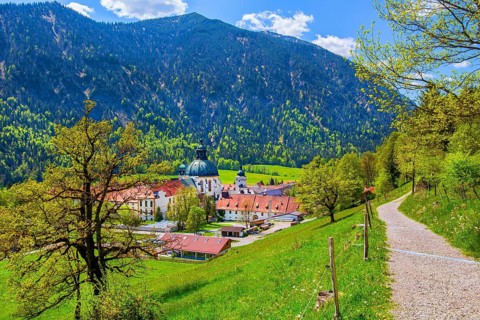 Hiking trail with Ettal Monastery in spring, municipality of Ettal, Ammergau Alps, Upper Bavaria,