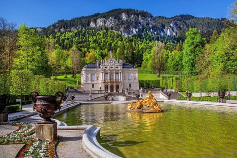 Water parterre with flora fountain and the portal of Linderhof Castle in spring, municipality of