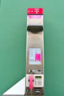 Public telephone on a green wall, Wismar, Mecklenburg-Vorpommern, Germany