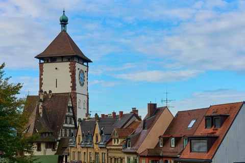 Schwabentor and half-timbered houses under a blue sky, Freiburg im Breisgau, Black Forest,