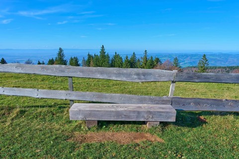 Wooden bench, on the Kandel Höhenweg, with a wide view over wooded landscape, Kandel, Waldkirch,