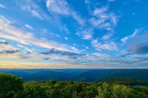 Fresh evening sky sunset over lush forest, clouds passing by, Katzenbuckel, Waldbrunn,
