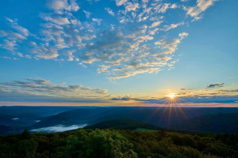Sunrise over wooded hills, sky with light clouds and warm morning light, Katzenbuckel, Waldbrunn,