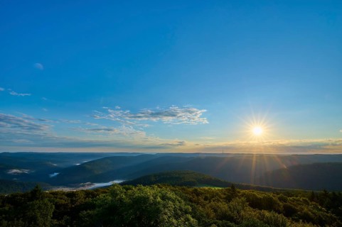 Sunrise with clear sky and wide view over wooded hills, Katzenbuckel, Waldbrunn,