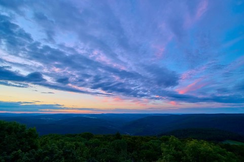 Purple and pink clouds fill the night sky over a forest landscape, twilight, Katzenbuckel,