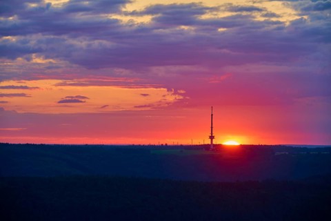 A bright sunrise with a prominent transmitter mast, Reisenbach transmitter, seen from the