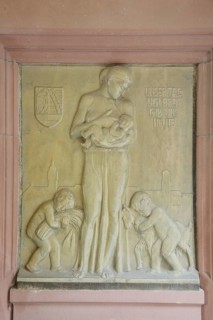 Relief in the inner courtyard of the town hall with inscription Give us today our daily bread,