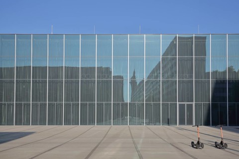 Bauhaus Museum, modern glass building, glass windows, two parked e-scooters, parking, Dessau,