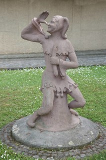 Sculpture of Till Eulenspiegel with gesture, thumb on nose, arm, high, up, hand, Bernburg,