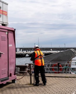 Worker with safety waistcoat in the city harbour of Sassnitz, Rügen, Mecklenburg-Vorpommern,