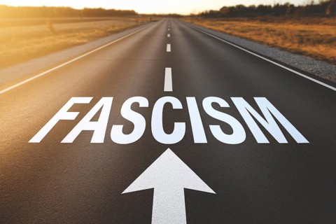 Street with white word 'Fascism' and arrow written on it with storm in sky. Concpet for countries